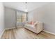 Bright bedroom with wood floors, large window, and daybed with pink pillows at 1203 Bay Club Cir # 1203, Tampa, FL 33607