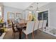 Formal dining room featuring a large wooden table, seating for eight, and elegant decor at 1203 Bay Club Cir # 1203, Tampa, FL 33607