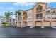 Exterior of a multi-story condo building with private garages and screened balconies at 1203 Bay Club Cir # 1203, Tampa, FL 33607
