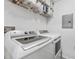 Laundry room featuring a white washer and dryer, wire shelving and a utility panel at 1203 Bay Club Cir # 1203, Tampa, FL 33607