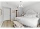 Airy main bedroom featuring light hardwood floors, large window, and stylish white furniture at 1203 Bay Club Cir # 1203, Tampa, FL 33607