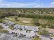 An aerial view of the complex, with golf course, lush landscaping and trees surrounding at 16211 Rambling Vine W Dr, Tampa, FL 33624