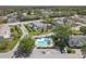 Beautiful aerial view of a residential community with a pool and well-maintained landscaping at 16211 Rambling Vine W Dr, Tampa, FL 33624