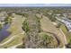 Aerial view of golf course, complex, water features and landscaping at 16211 Rambling Vine W Dr, Tampa, FL 33624