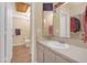 This home bathroom features a large mirror, a sink, and a toilet room at 16211 Rambling Vine W Dr, Tampa, FL 33624