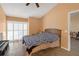 Relaxing bedroom features tile floors, a bed, and plantation shutters on sliding doors at 16211 Rambling Vine W Dr, Tampa, FL 33624