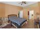 This bedroom features tile floors, a bed, and multiple entry ways at 16211 Rambling Vine W Dr, Tampa, FL 33624