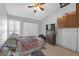 Comfortable bedroom with a ceiling fan, built-in storage, and a window for natural light at 16211 Rambling Vine W Dr, Tampa, FL 33624