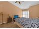 This bedroom features a ceiling fan, bed, bedside table, and closet access at 16211 Rambling Vine W Dr, Tampa, FL 33624
