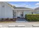 Charming single-story home with covered entrance, light blue siding, and a well-maintained front yard at 16211 Rambling Vine W Dr, Tampa, FL 33624
