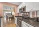 This is an eat-in kitchen with stainless steel appliances and a view into the dining and living area at 16211 Rambling Vine W Dr, Tampa, FL 33624