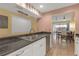 The kitchen features a dual sink with granite countertops and ample storage and is adjacent to the dining area at 16211 Rambling Vine W Dr, Tampa, FL 33624