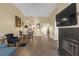 Cozy living room with a fireplace, wood floors, dining table, and modern furnishings for comfortable living at 16211 Rambling Vine W Dr, Tampa, FL 33624