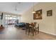 Open living and dining area with wood floors, modern furniture, and a sliding glass door to the patio at 16211 Rambling Vine W Dr, Tampa, FL 33624
