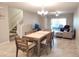 Open-concept dining area features tile floors and a chandelier lighting fixture at 17009 Clear Cork Dr, Wimauma, FL 33598