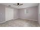 Bedroom features a ceiling fan, closet and natural light at 4925 Beacon Hill Dr, New Port Richey, FL 34652