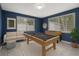 Entertaining game room with pool table and foosball table by natural light from the windows at 4925 Beacon Hill Dr, New Port Richey, FL 34652
