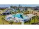 Aerial view of community amenities featuring a pool, clubhouse and lounging area at 6684 Devlin Ln, Wesley Chapel, FL 33545
