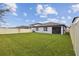 Spacious backyard featuring lush grass and a privacy fence, great for outdoor activities at 6684 Devlin Ln, Wesley Chapel, FL 33545