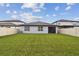 Spacious backyard featuring lush grass and a privacy fence, great for outdoor activities at 6684 Devlin Ln, Wesley Chapel, FL 33545