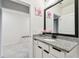 Well-lit bathroom featuring a granite countertop, white cabinets, and a decorative floral arrangement at 6684 Devlin Ln, Wesley Chapel, FL 33545