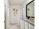 Bathroom with granite counters, a mirror, and Sunflower art at 6684 Devlin Ln, Wesley Chapel, FL 33545
