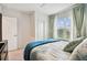 Well-lit bedroom with a spacious closet, and a comfortable bed by a bright window at 6684 Devlin Ln, Wesley Chapel, FL 33545