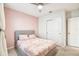 Bright bedroom featuring a cozy bed with stylish bedding and a ceiling fan, perfect for relaxation at 6684 Devlin Ln, Wesley Chapel, FL 33545