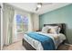 Serene bedroom with a large window, soft drapery, and a comfortable bed with plush pillows at 6684 Devlin Ln, Wesley Chapel, FL 33545