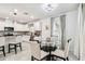Eat-in kitchen area with white cabinets and stainless appliances, adjacent to the dining area at 6684 Devlin Ln, Wesley Chapel, FL 33545
