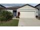 Charming single-story home featuring a two-car garage and well-manicured lawn at 6684 Devlin Ln, Wesley Chapel, FL 33545