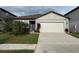 Charming single-story home featuring a two-car garage and well-manicured lawn at 6684 Devlin Ln, Wesley Chapel, FL 33545