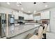 Modern kitchen with stainless steel appliances, granite countertops, and pendant lighting at 6684 Devlin Ln, Wesley Chapel, FL 33545