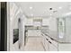 Contemporary kitchen with stainless steel appliances, granite counters, white cabinets, and an island with drawers at 6684 Devlin Ln, Wesley Chapel, FL 33545