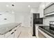 Kitchen boasts white cabinets, stainless steel appliances, granite countertops, and a large center island at 6684 Devlin Ln, Wesley Chapel, FL 33545