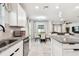 Bright kitchen with granite countertops, stainless steel appliances, and adjacent dining area at 6684 Devlin Ln, Wesley Chapel, FL 33545