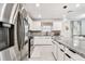 Well-lit kitchen with stainless steel appliances, granite countertops, and a neutral backsplash at 6684 Devlin Ln, Wesley Chapel, FL 33545