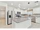 Bright kitchen features stainless steel appliances, granite countertops, and a large center island at 6684 Devlin Ln, Wesley Chapel, FL 33545