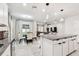Open floor plan kitchen featuring granite island, dining area, and view of living room at 6684 Devlin Ln, Wesley Chapel, FL 33545