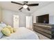 Inviting main bedroom featuring a comfortable bed, carpeted flooring, ceiling fan, and ensuite bathroom at 6684 Devlin Ln, Wesley Chapel, FL 33545