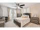 Comfortable main bedroom featuring plush carpet, a ceiling fan, dresser, and soft, natural light at 6684 Devlin Ln, Wesley Chapel, FL 33545