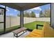 Screened patio with comfortable seating and a view of a well-maintained fenced backyard at 6684 Devlin Ln, Wesley Chapel, FL 33545