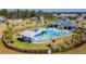 Community pool with slide, covered seating area and palm trees at 6684 Devlin Ln, Wesley Chapel, FL 33545