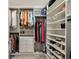 Spacious walk-in closet offering ample storage with rods, drawers, and shelves at 6684 Devlin Ln, Wesley Chapel, FL 33545