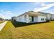 Well-maintained backyard with a lawn and covered patio at 682 Olive Conch St, Ruskin, FL 33570