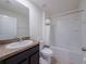 Bright bathroom with a shower-tub combo, white fixtures, and a granite vanity at 682 Olive Conch St, Ruskin, FL 33570