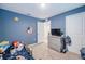room features a space theme with wall decals, a gray dresser and carpeted floors at 682 Olive Conch St, Ruskin, FL 33570