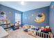 bedroom features space theme with playful wall art and a cozy bed with colorful toys at 682 Olive Conch St, Ruskin, FL 33570