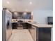 Well-lit kitchen with stainless steel appliances, a granite countertop, and tiled floor at 682 Olive Conch St, Ruskin, FL 33570