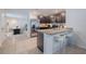 Open kitchen with stainless steel appliances, granite countertops, and breakfast bar seating at 682 Olive Conch St, Ruskin, FL 33570